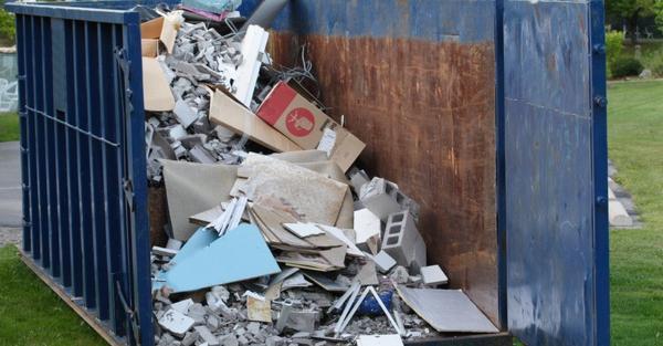 dumpster with trash spilling out
